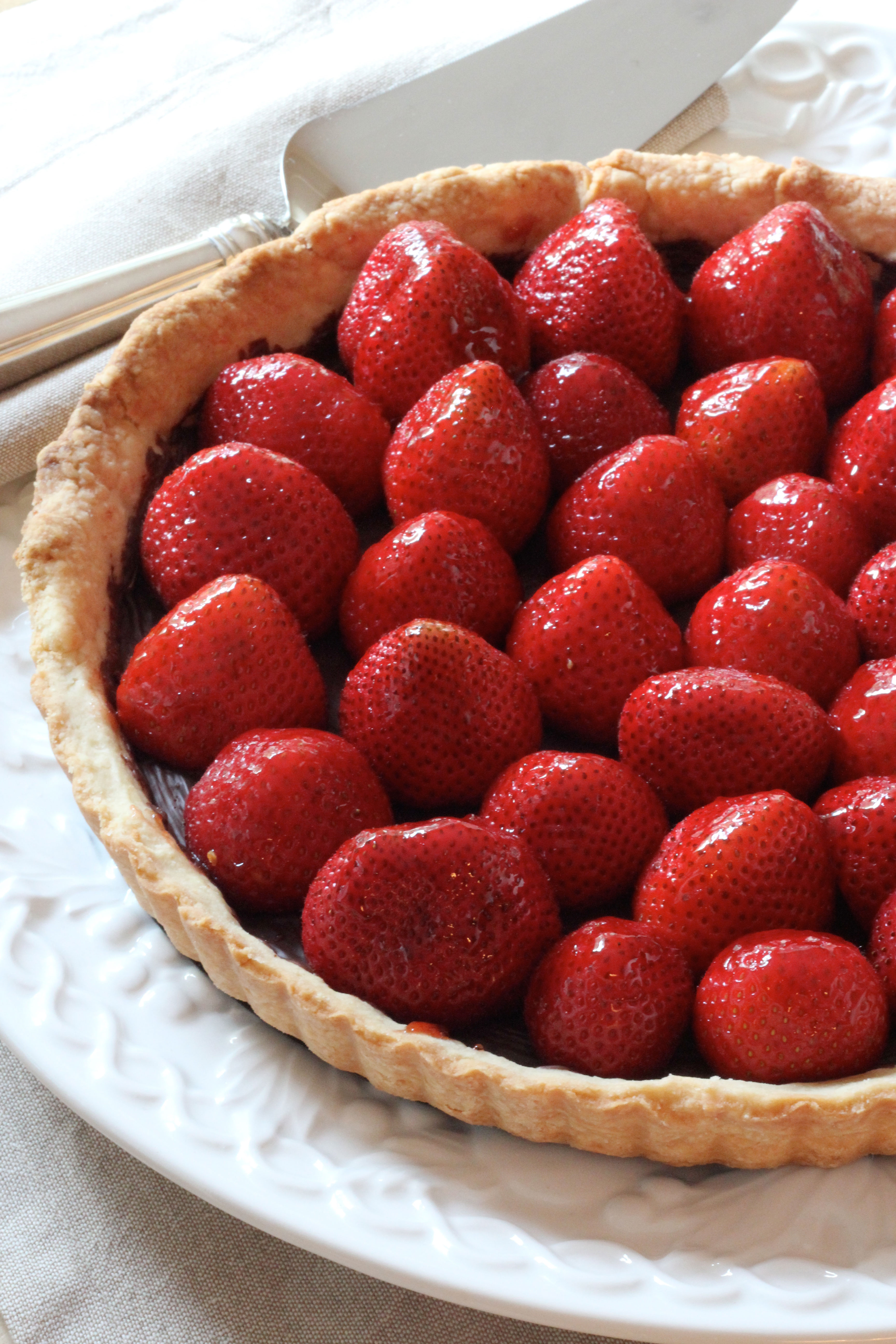 Fresh Strawberries, a light Pâte Sucrée dough with a hint of chocolate and you have a super Summer dessert! Make this Strawberry Tart and WOW your guests!
