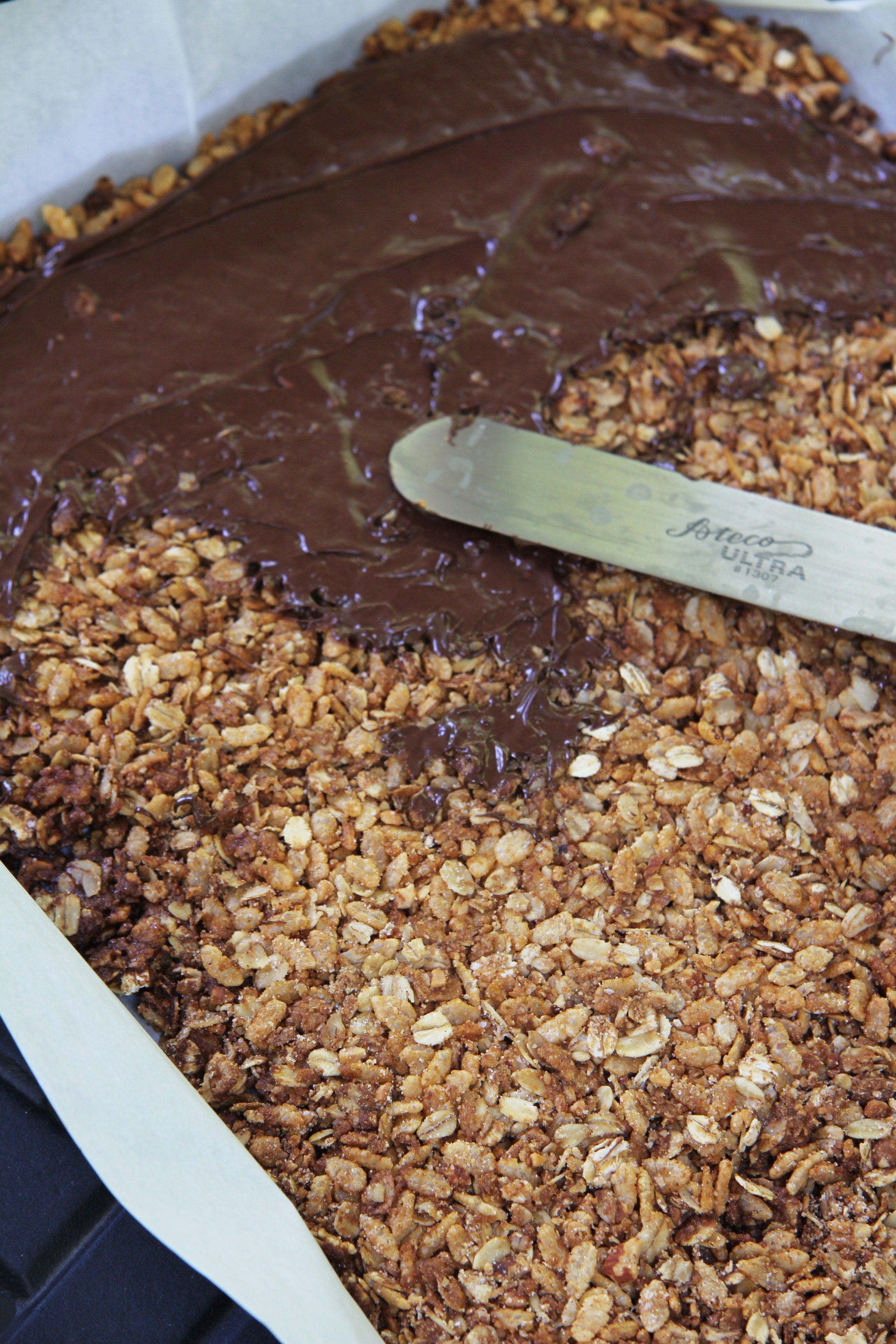 Make these Dark Chocolate covered granola bars by melting and spreading chocolate with an offset spatula.