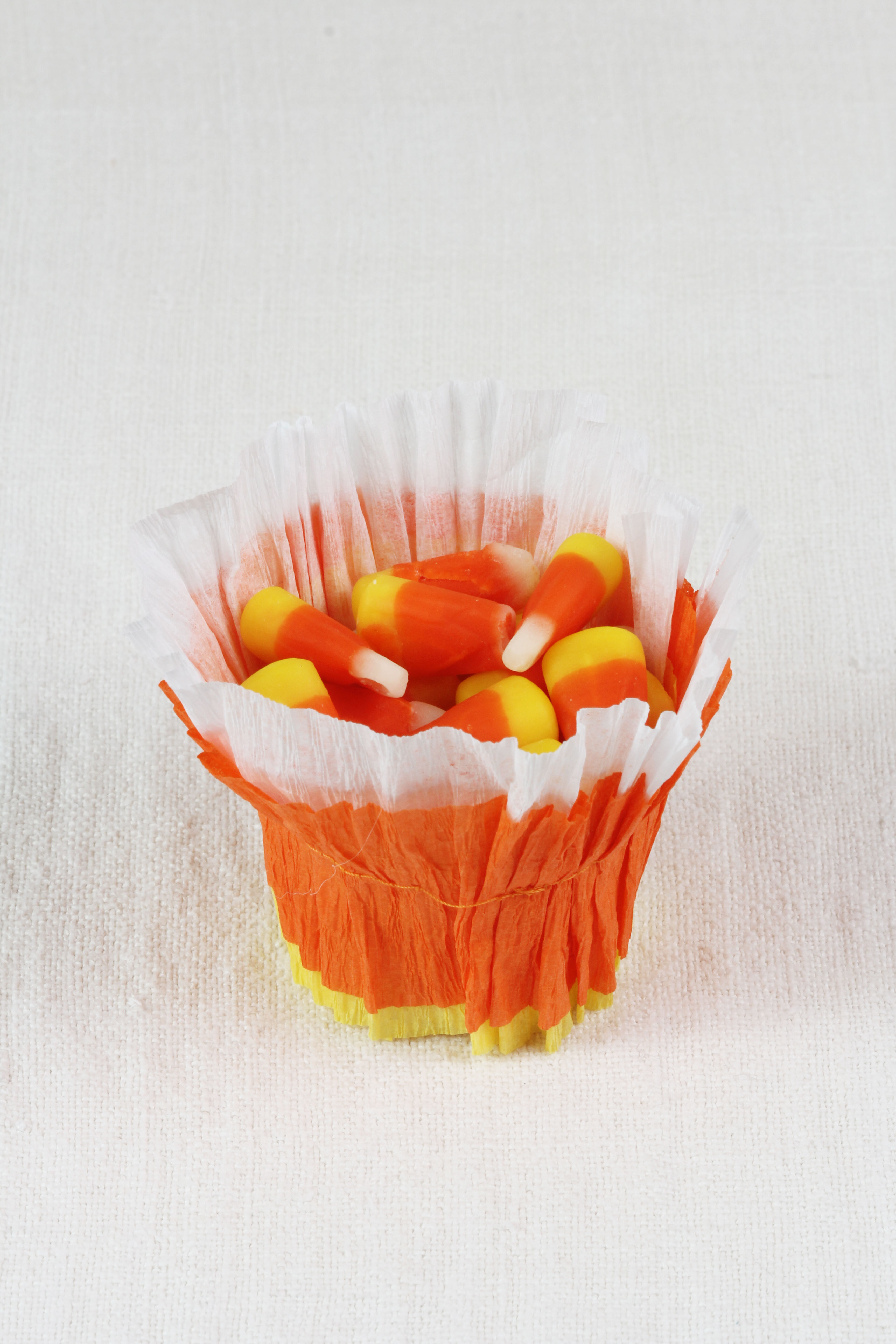 Make these festive DIY Individual Candy Corn Baskets for everyone at the table! Perfect size for a handful of candy corns or colored M&M's.