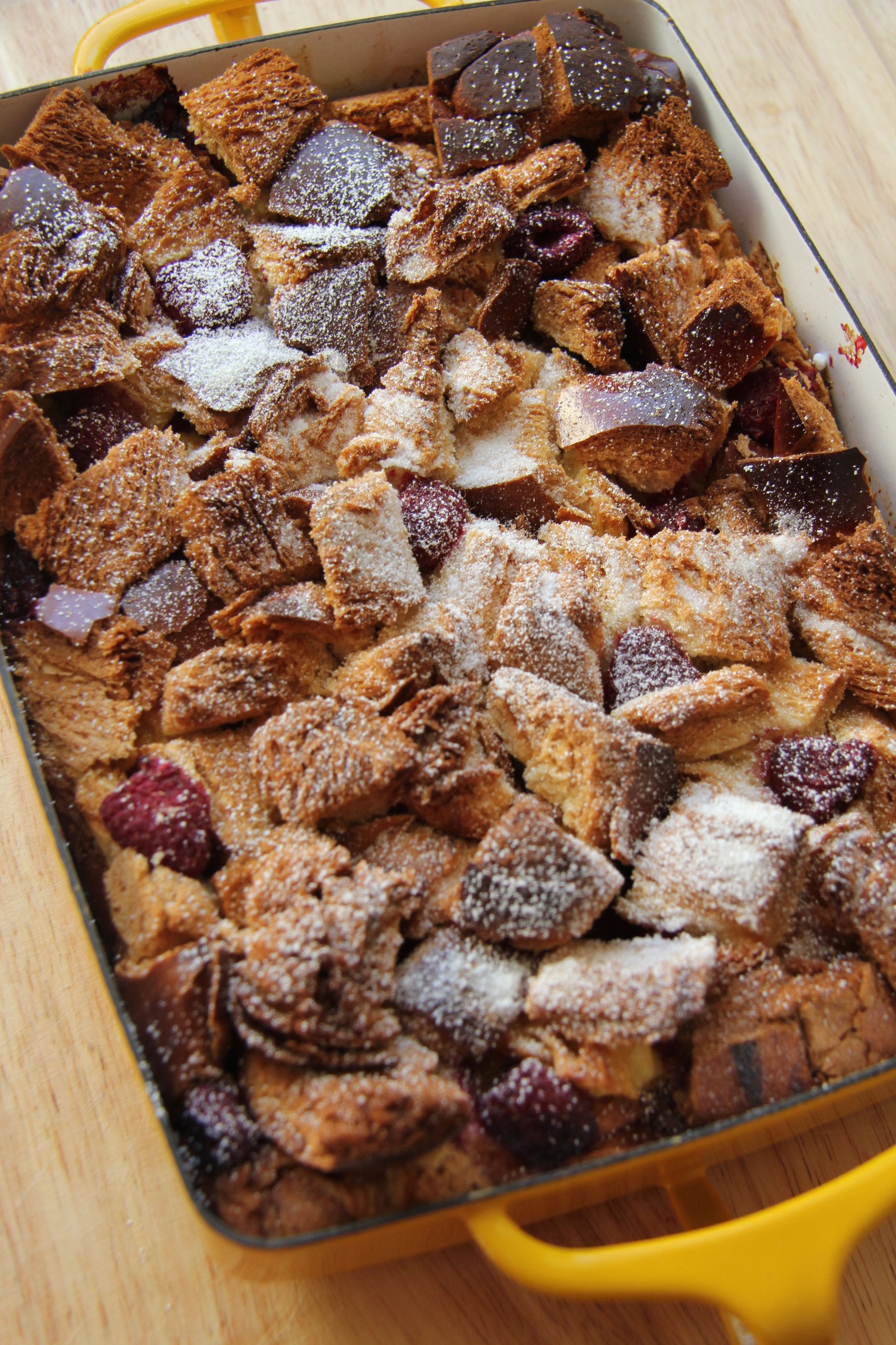 Want a guest worthy brunch recipe? This Raspberry Baked French Bread pudding has a crusty top, soft middle and sweet of berries.. it is divine!