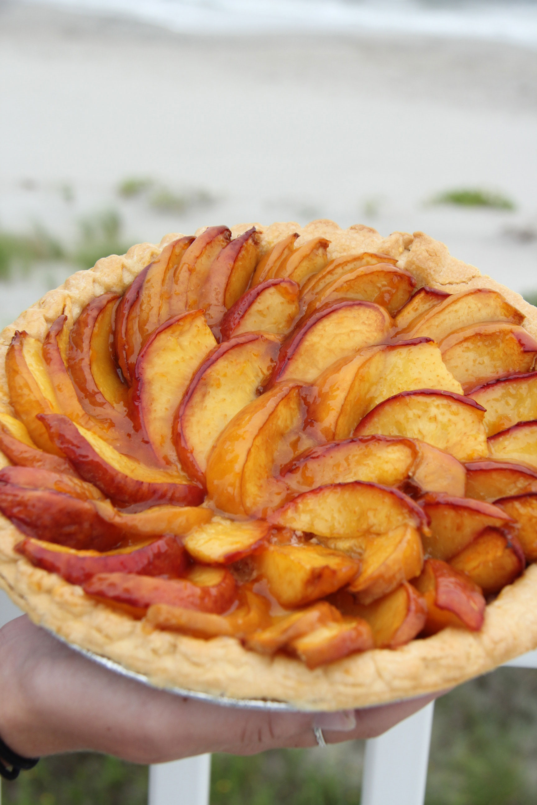 Fresh peaches, a hint of homemade almond paste and a flakey crust make this rustic tart a winner! The best dessert, with the taste of Summer in every bite!
