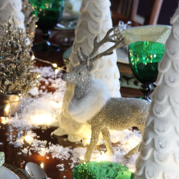 See how to create a magical snowy table for your Christmas gatherings. Don't forget the sparkly reindeer, faux snow and fairy lights!
