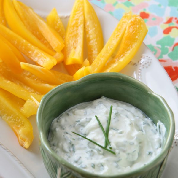 Lifestyle Blogger, Ridgely Brode srrves up a relatively healthy roasted garlic and chive dip with sliced yellow peppers on her blog.