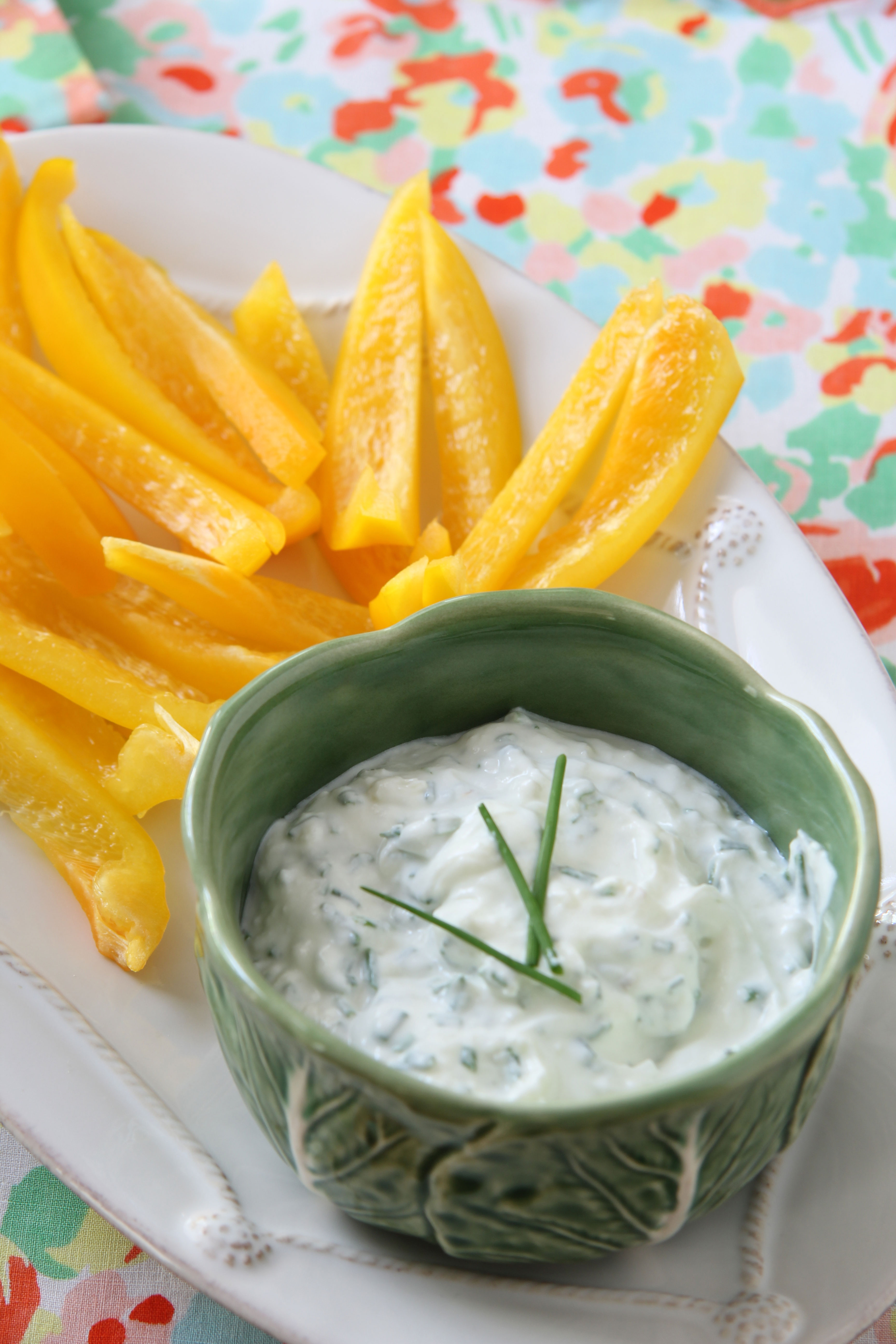 Lifestyle Blogger, Ridgely Brode srrves up a relatively healthy roasted garlic and chive dip with sliced yellow peppers on her blog.