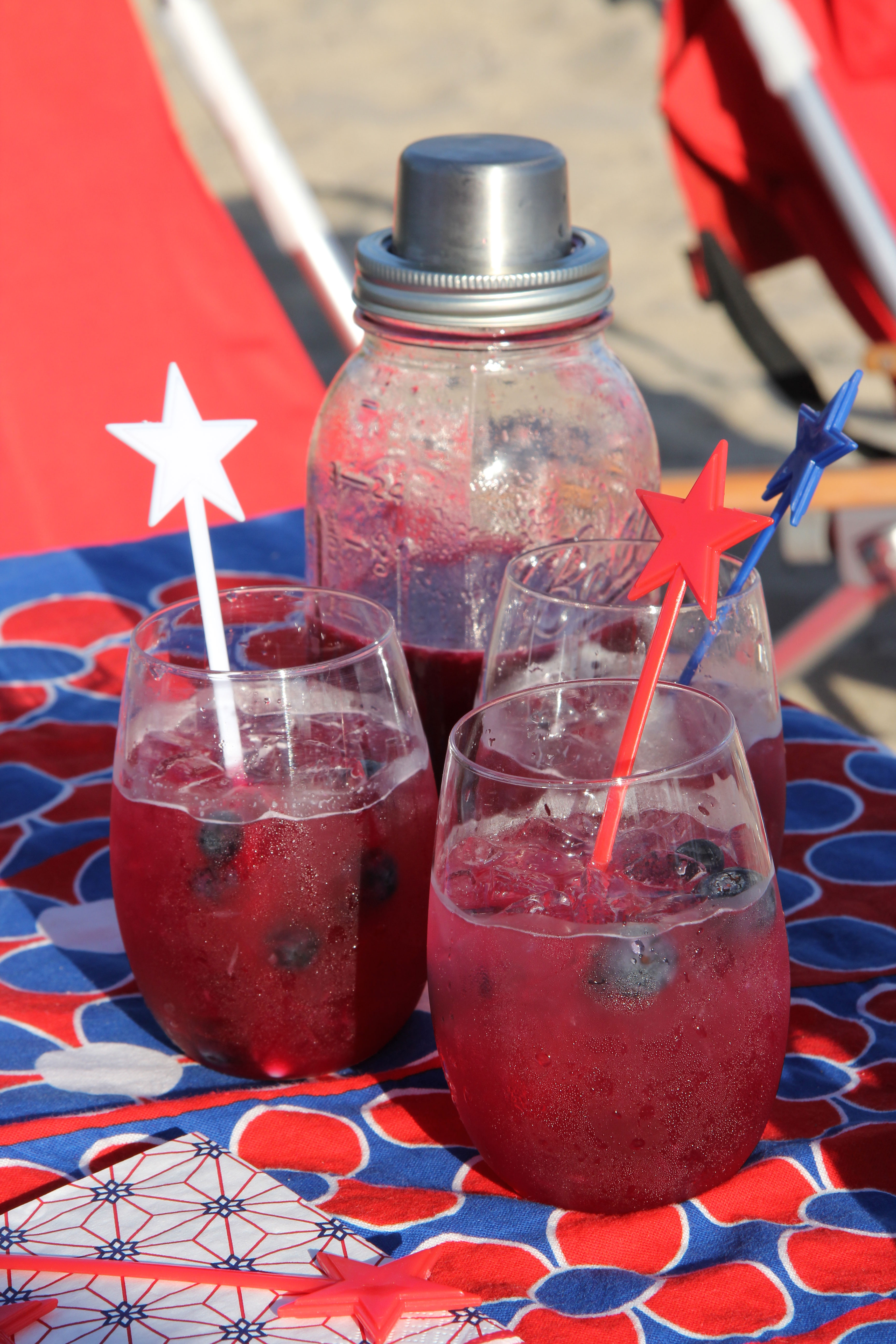 Serve up these fun Spiked Blueberry Limeade cocktails that taste delicious - looks festive and will quickly disappear! And they are red blue and white for any patriotic theme!
